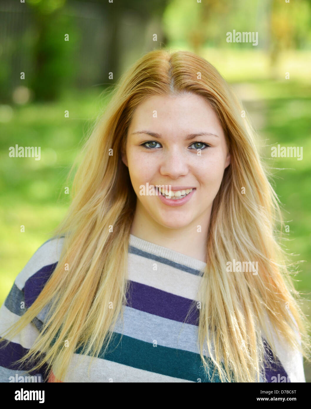 Portrait of smiling girl outdoors Stock Photo - Alamy