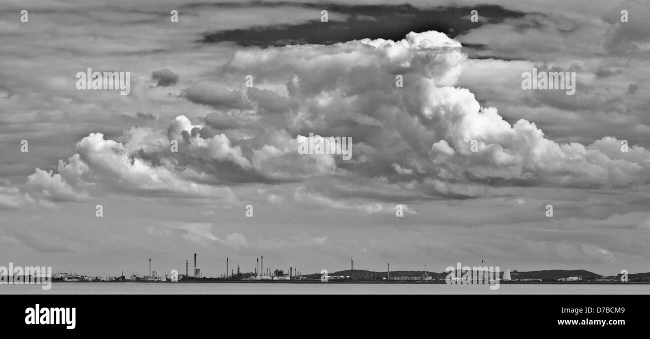 Storm clouds gather overr oil refinery Stock Photo