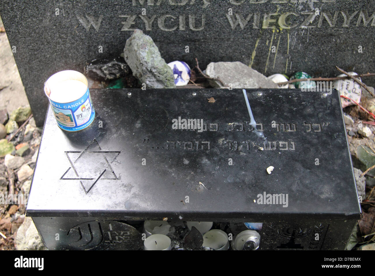 Memorial candles lit by the common grave of Warsaw ghetto victims at Jewish Cemetery in Warsaw, Poland Stock Photo