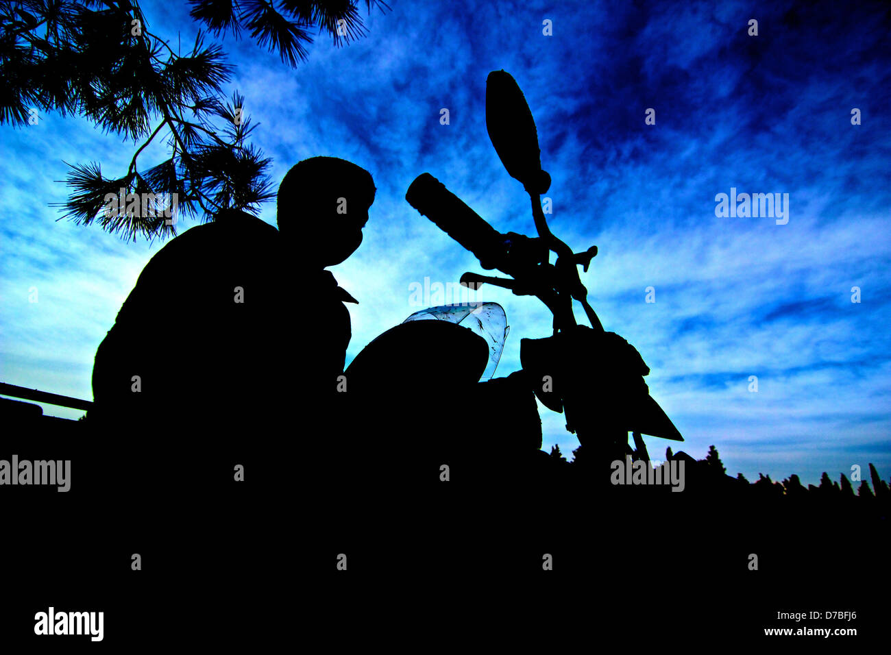 a silhouette of a young atv rider Stock Photo