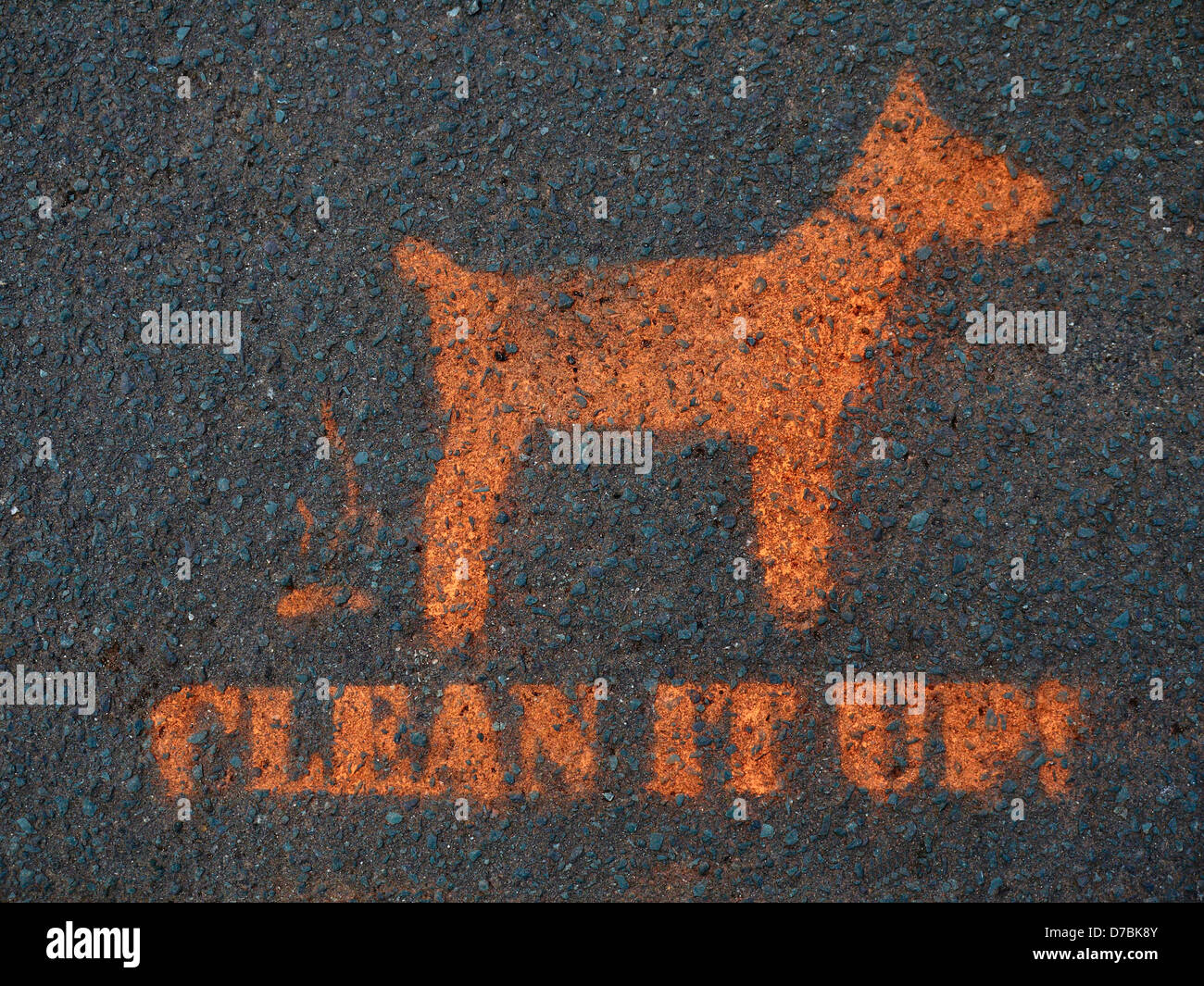 Stenciled "Clean it up!" sign on pavement Stock Photo