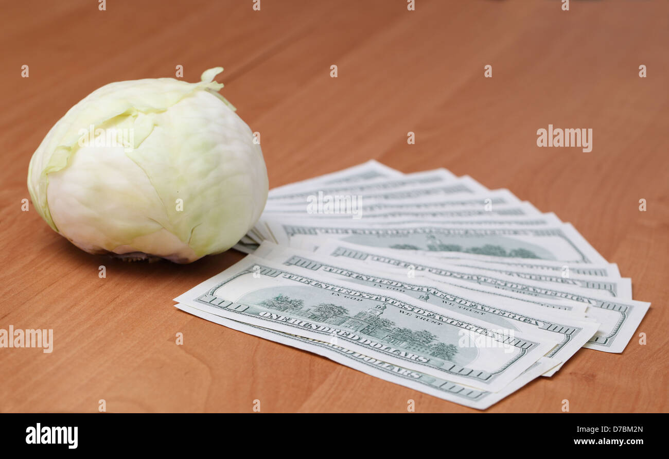 cabbage and dollar bills on the wooden table Stock Photo