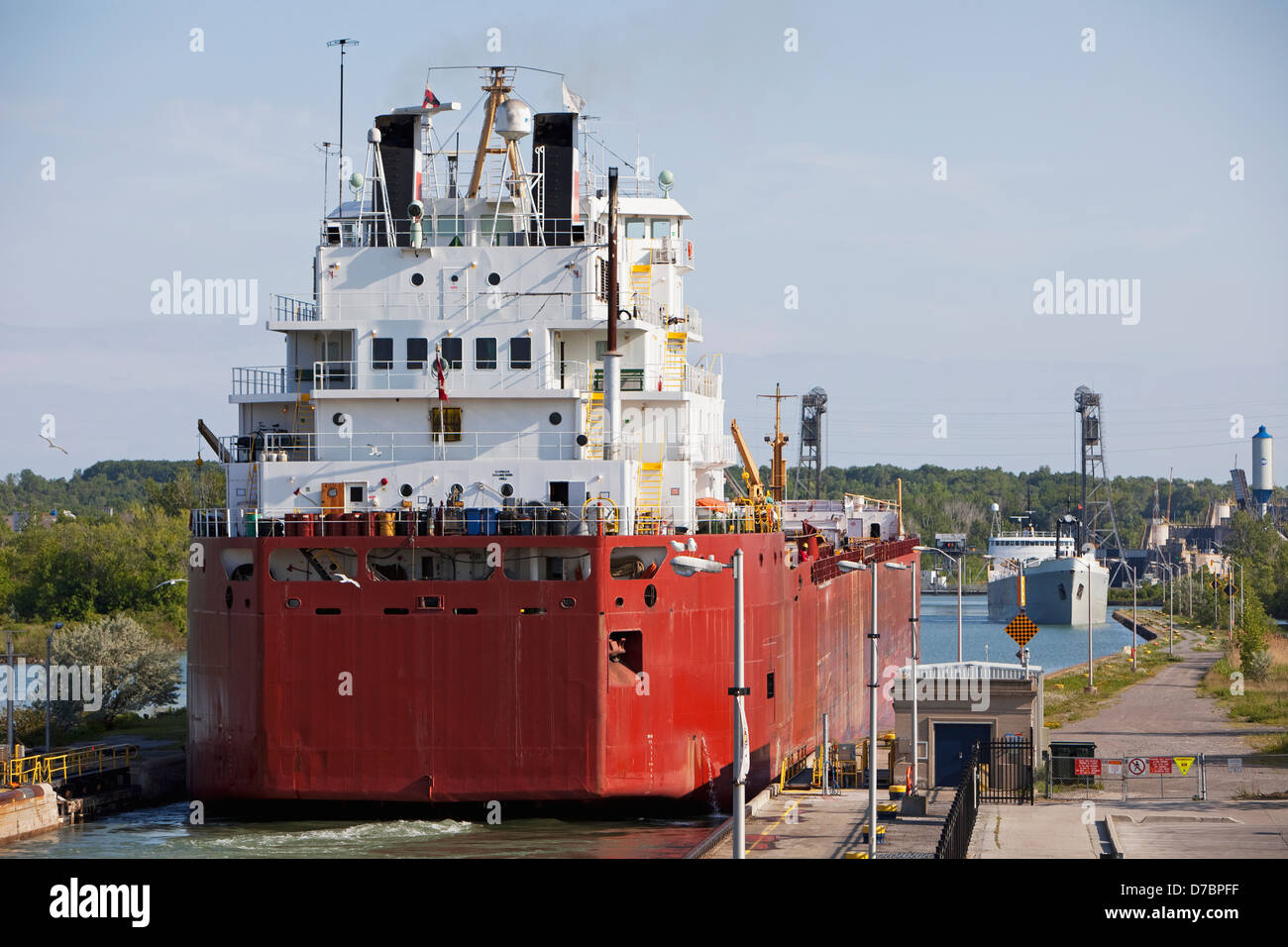 A Self-Unloading Bulk Freighter And A Cement Carrier At Lock 3 Of The Welland Canal;St. Catharines Ontario Canada Stock Photo