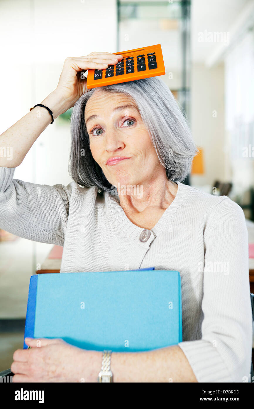 ELDERLY PERSON DOING PAPERWORK Stock Photo