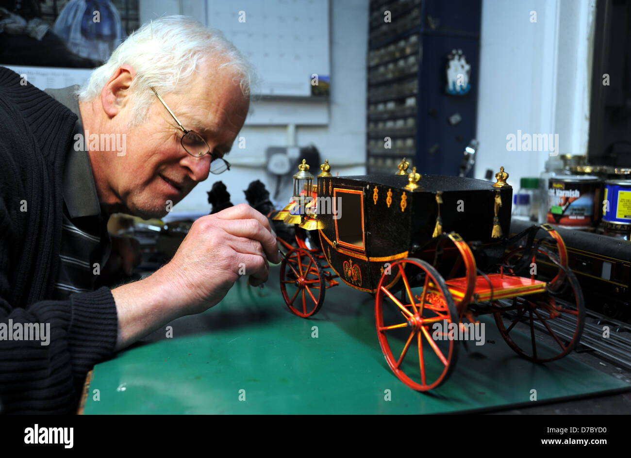 Chris Littledale from the Brighton Toy Museum renovating a very rare toy model of an English Royal coach Stock Photo