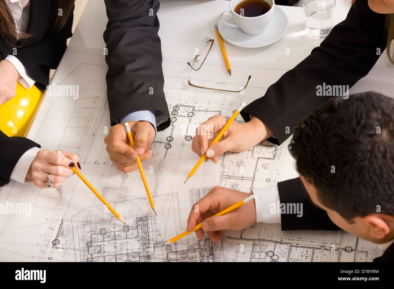 Businesspeople working together at meeting, discussing document Stock Photo