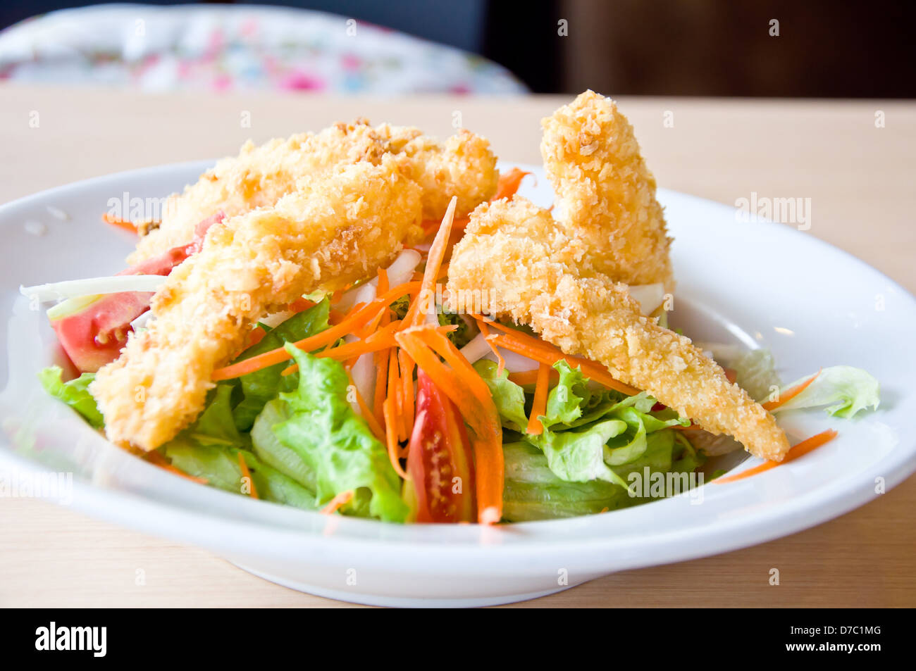 fried fish with salad for healthy eating Stock Photo - Alamy