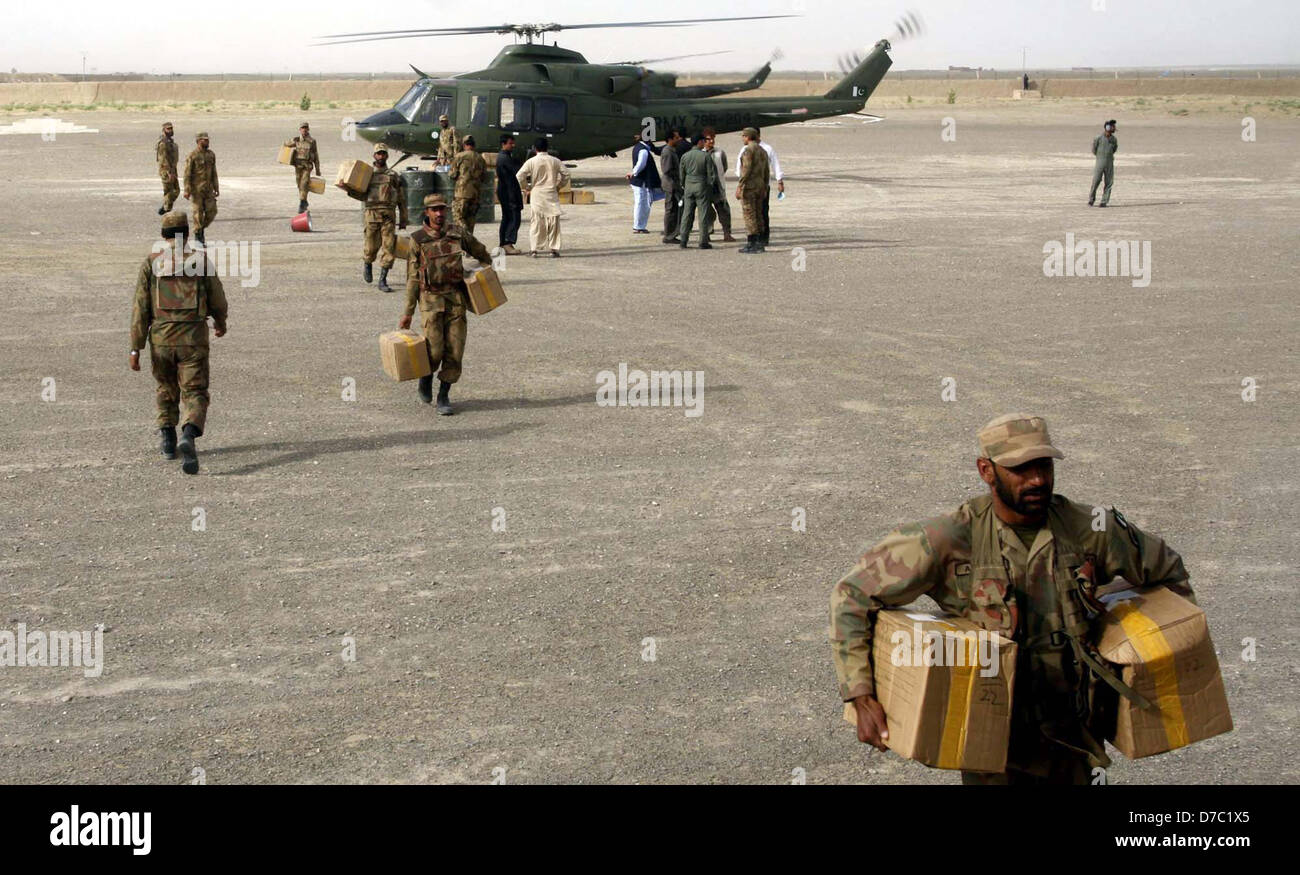 Pakistani Army soldiers carry the boxes of the ballot papers of PB-11 and NA-262 from the Army helicopter, at Qila Abdullah area in Chaman on Friday, 3rd May 2013, 2013. Election Commission of Pakistan supplied polling materials through the helicopter in Pakistan border town Chaman, District Qila Abdulla Chaman is declared sensitive  in Balochistan. Stock Photo