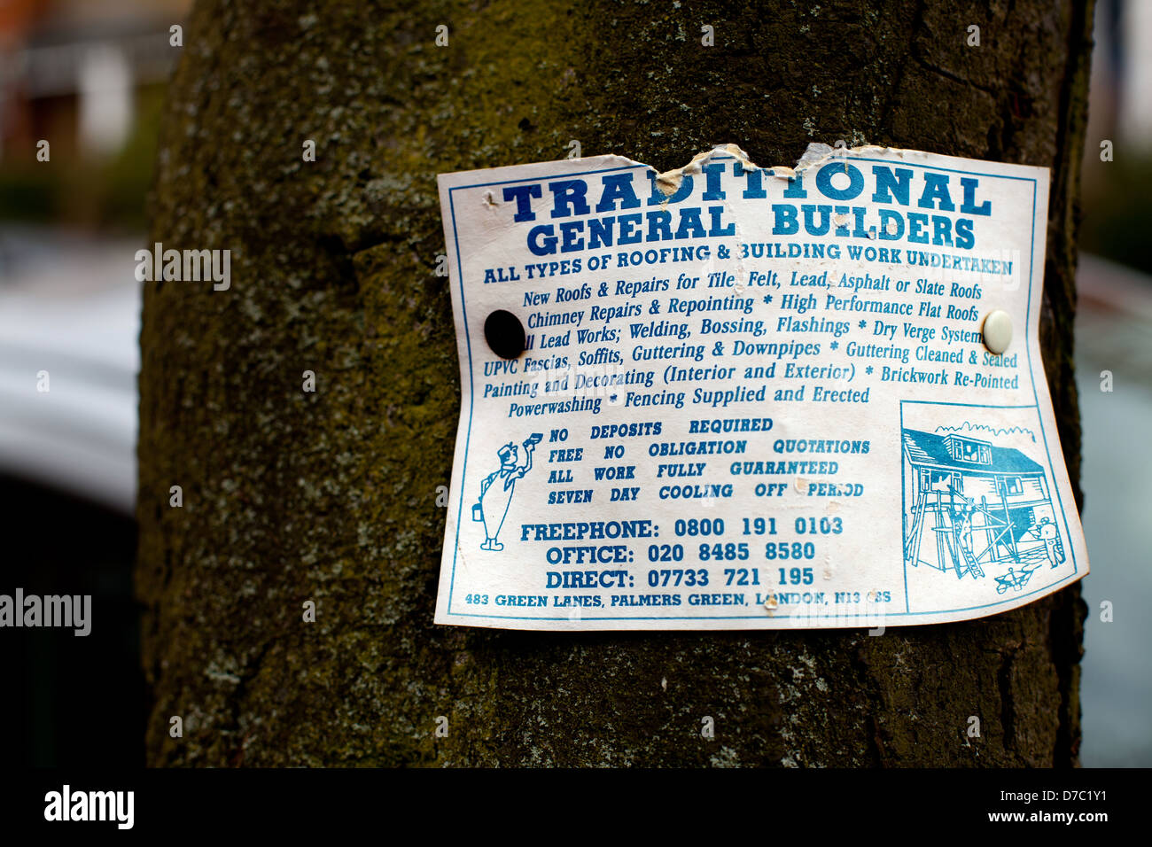 Local Builders advertising sign pinned on tree Stock Photo Alamy