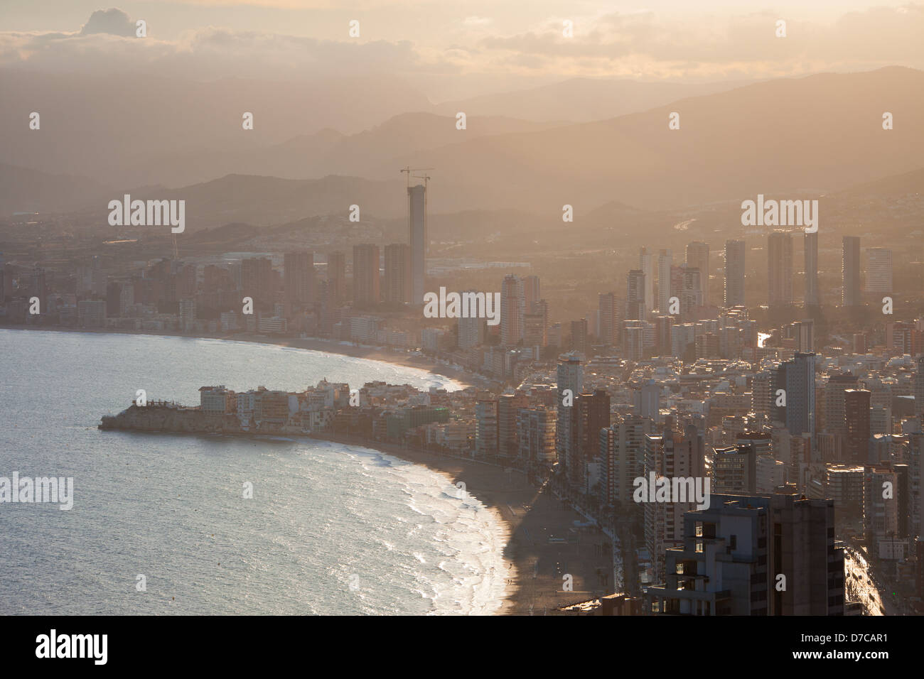 Famous Spanish city Benidorm at sunset - Levante beach at foreground Stock Photo