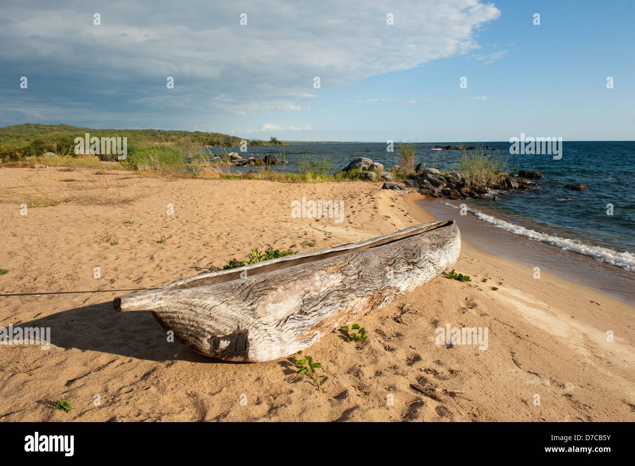 dugout canoe lying on a fishing beach, lake Niassa, Mozambique Stock Photo