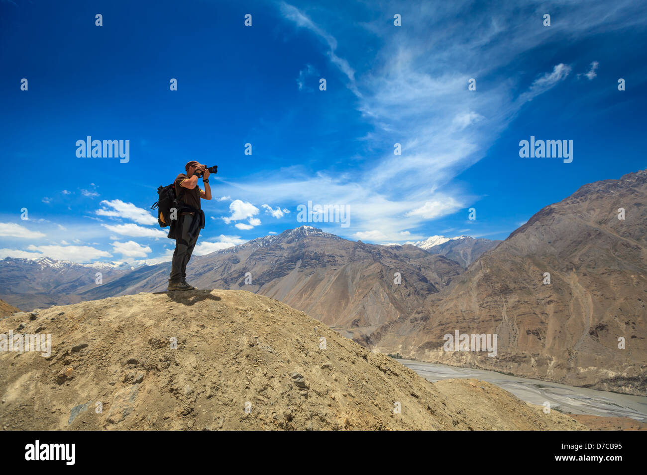 Photographer taking photos in Himalayas mountains. Spiti valley, Himachal Pradesh, India Stock Photo
