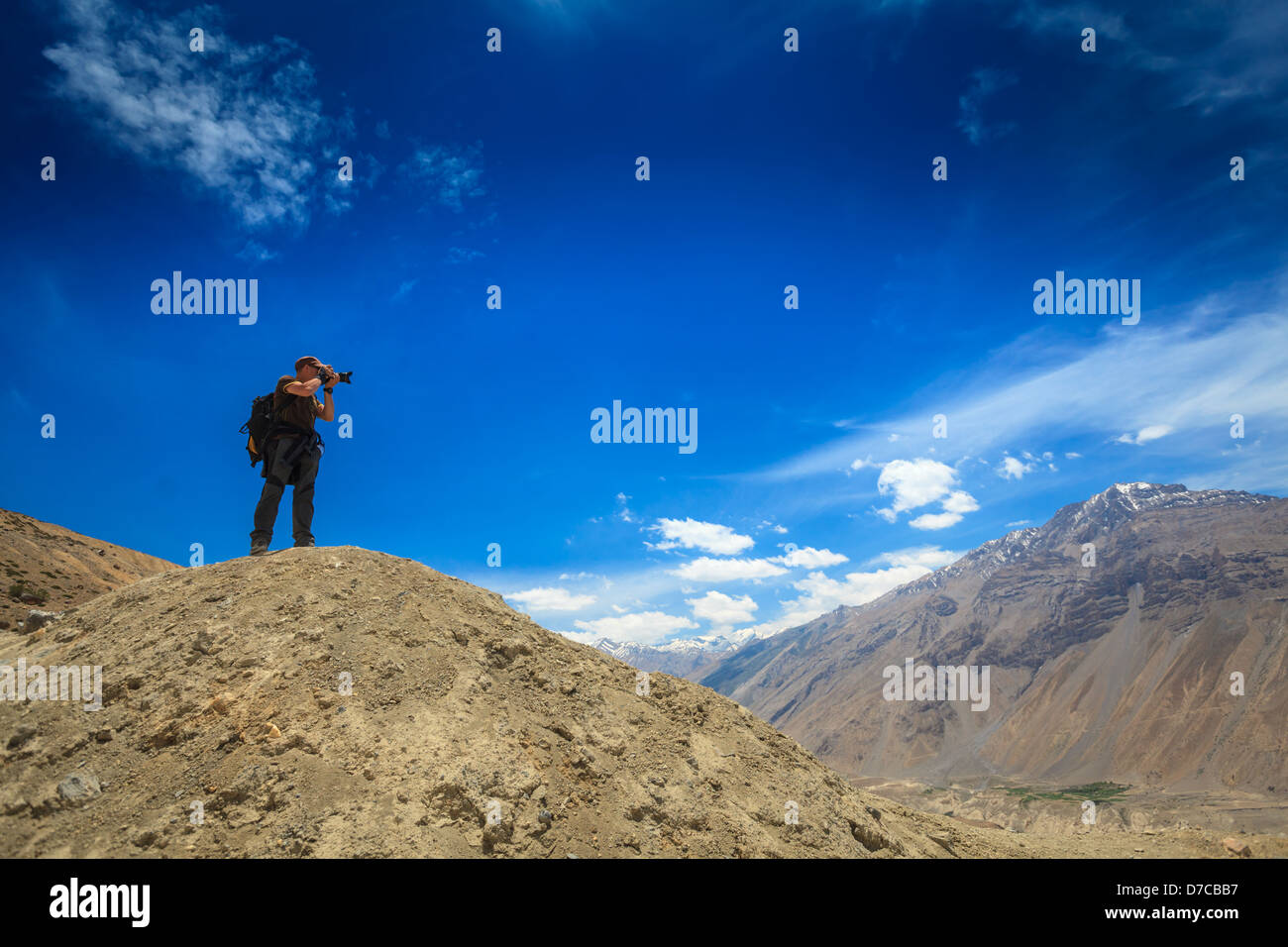Photographer taking photos in Himalayas mountains. Spiti valley, Himachal Pradesh, India Stock Photo