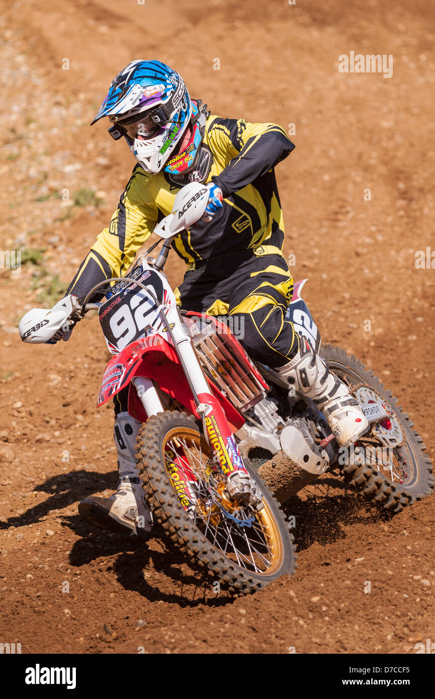 A motocross bike scrambler riding in the mud in the Uk Stock Photo