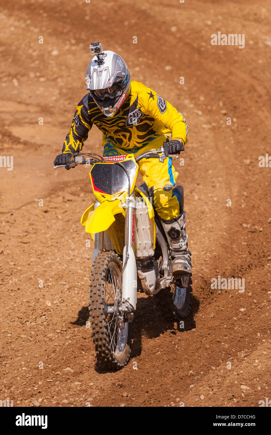 A motocross bike scrambler riding in the mud in the Uk Stock Photo