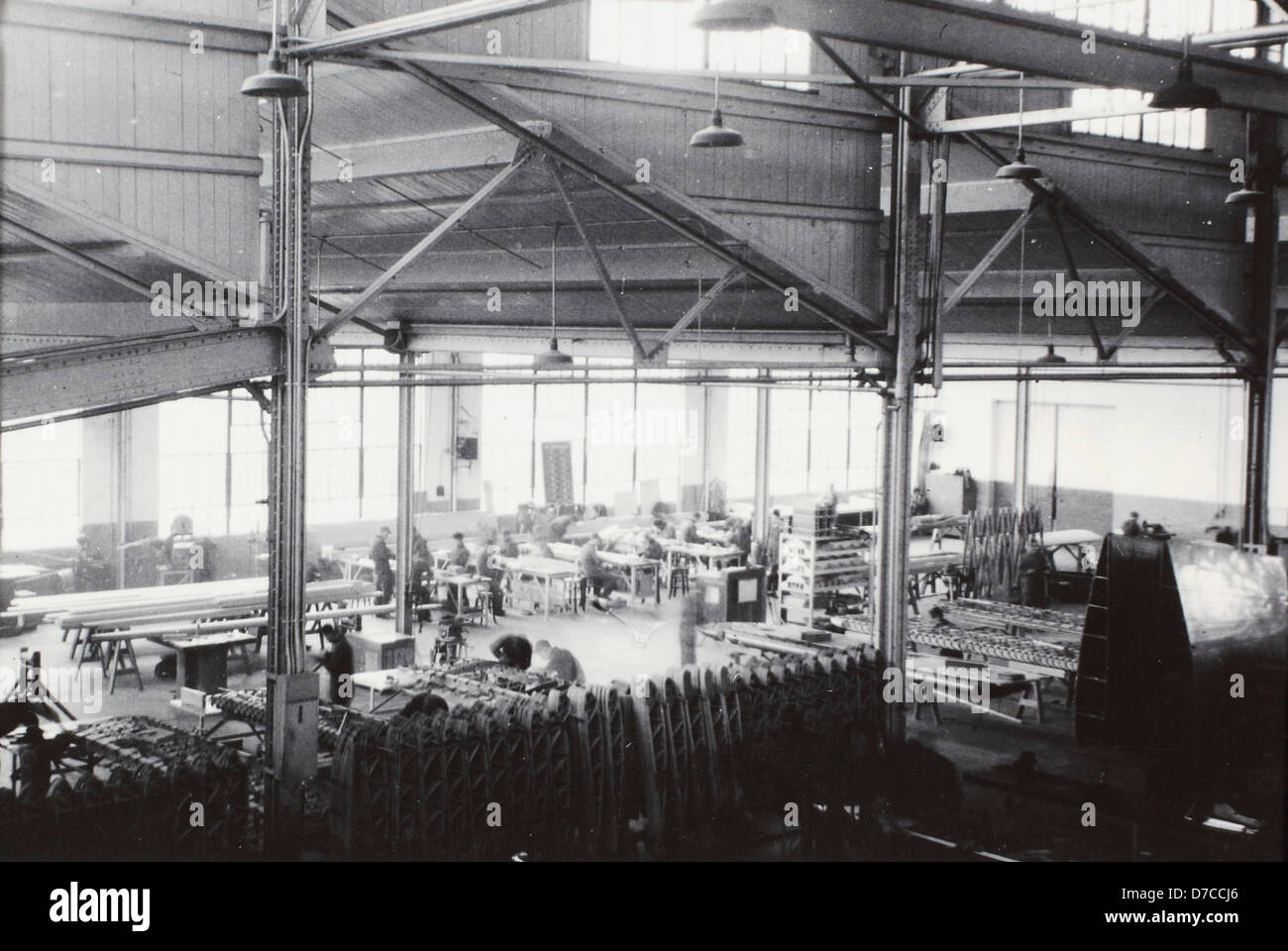 Mid Factory A photograph of the interior of a factory, showcasing workers and ...