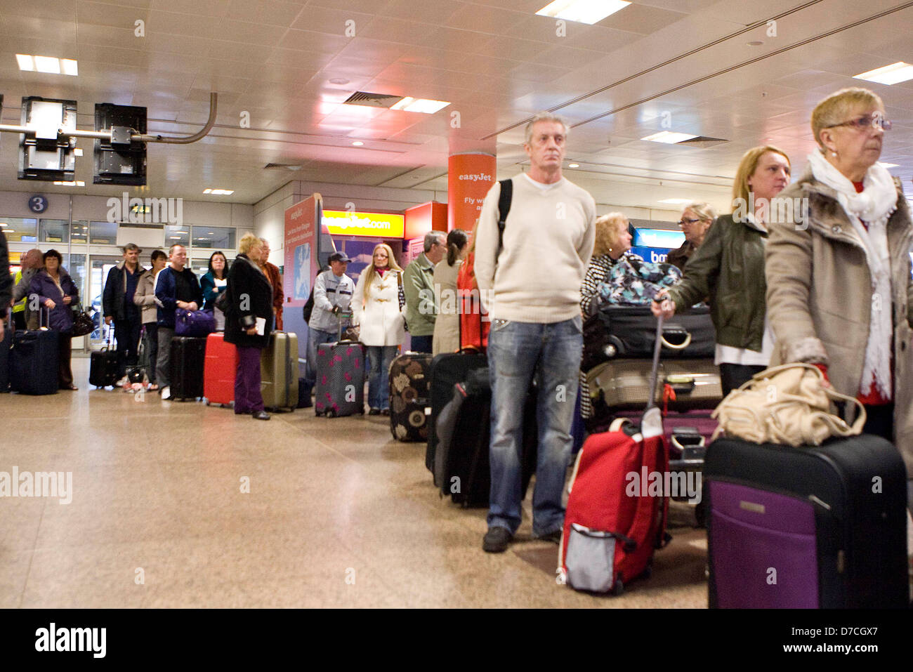 Passengers wait in line to pass through security at Glasgow Airport as more than 2 million public sector workers walk out on a Stock Photo