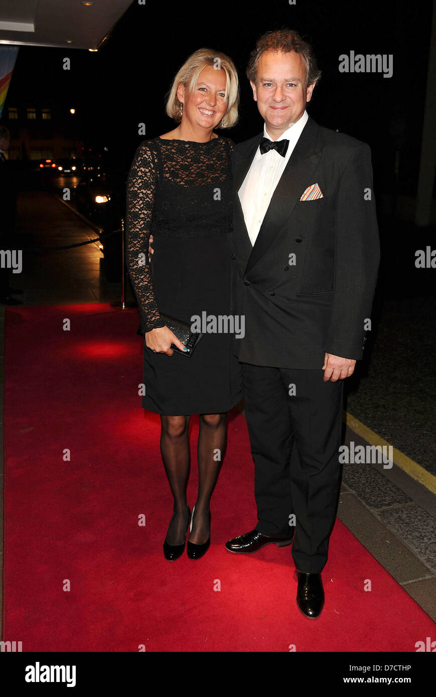 Hugh Bonneville and wife Lulu Evans arrives at the Rainbow Trust's Silver Jubilee Ball, The Savoy Hotel. London, England - Stock Photo