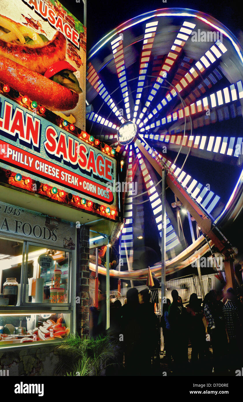 A night shot of the ferris wheel and hot dog stand at the Dixie Classic Fair. Stock Photo