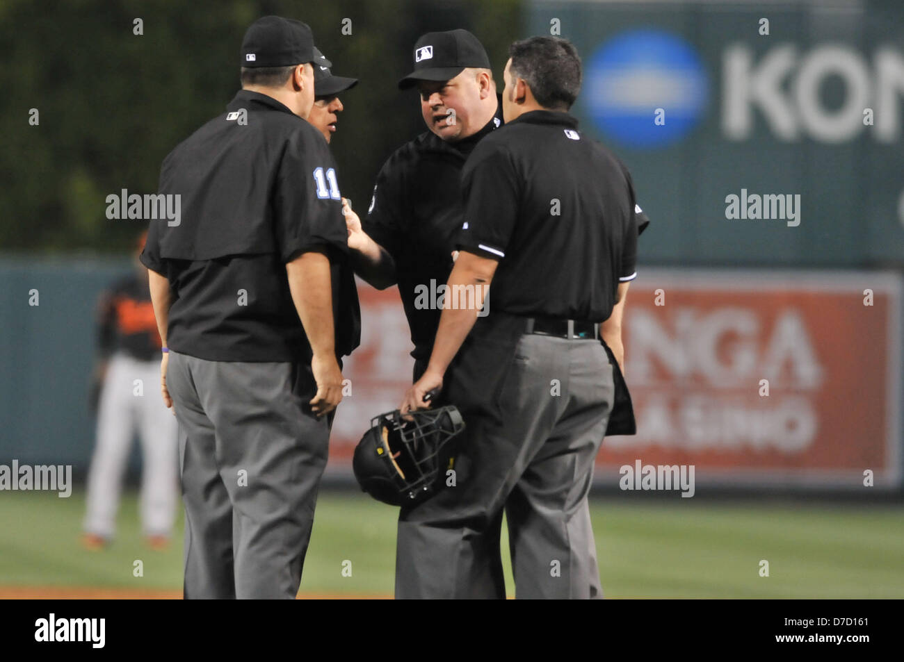 Anaheim, California, USA. 3rd May 2013. The umpires get together to talk about a double that may have been a home run off Angels' Erick Aybar, it was called a double after review, during the Major League Baseball game between the Baltimore Orioles and the Los Angeles Angels of Anaheim at Angel Stadium in Anaheim, California. Josh Thompson/Cal Sport Media/Alamy Live News Stock Photo