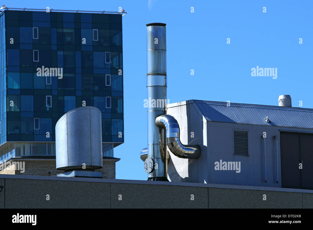 Vents of ventilation are located on a roof of a building Stock Photo