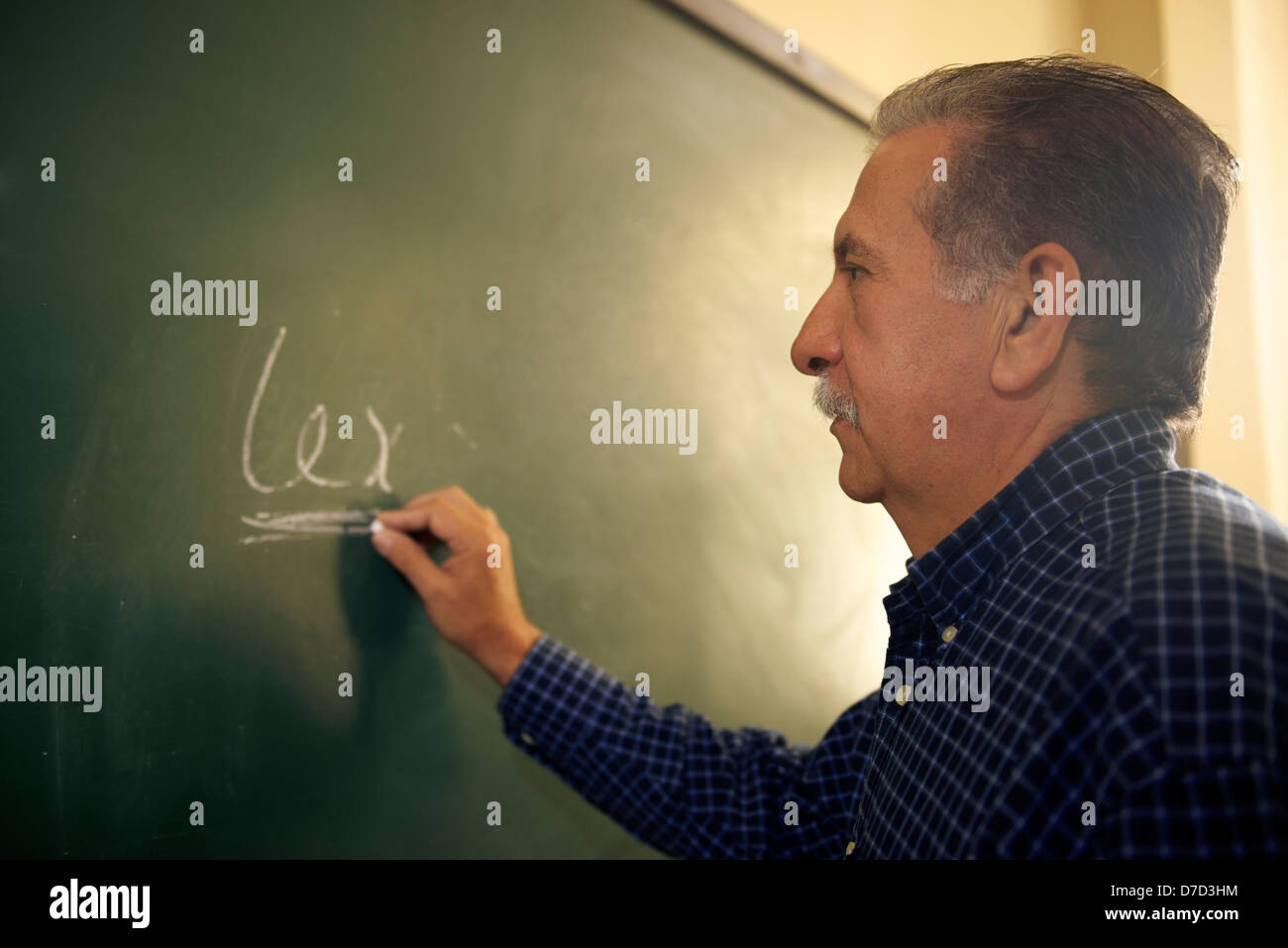 People and education, professor writing on board during lesson in college, Law School, University of Havana, Cuba Stock Photo