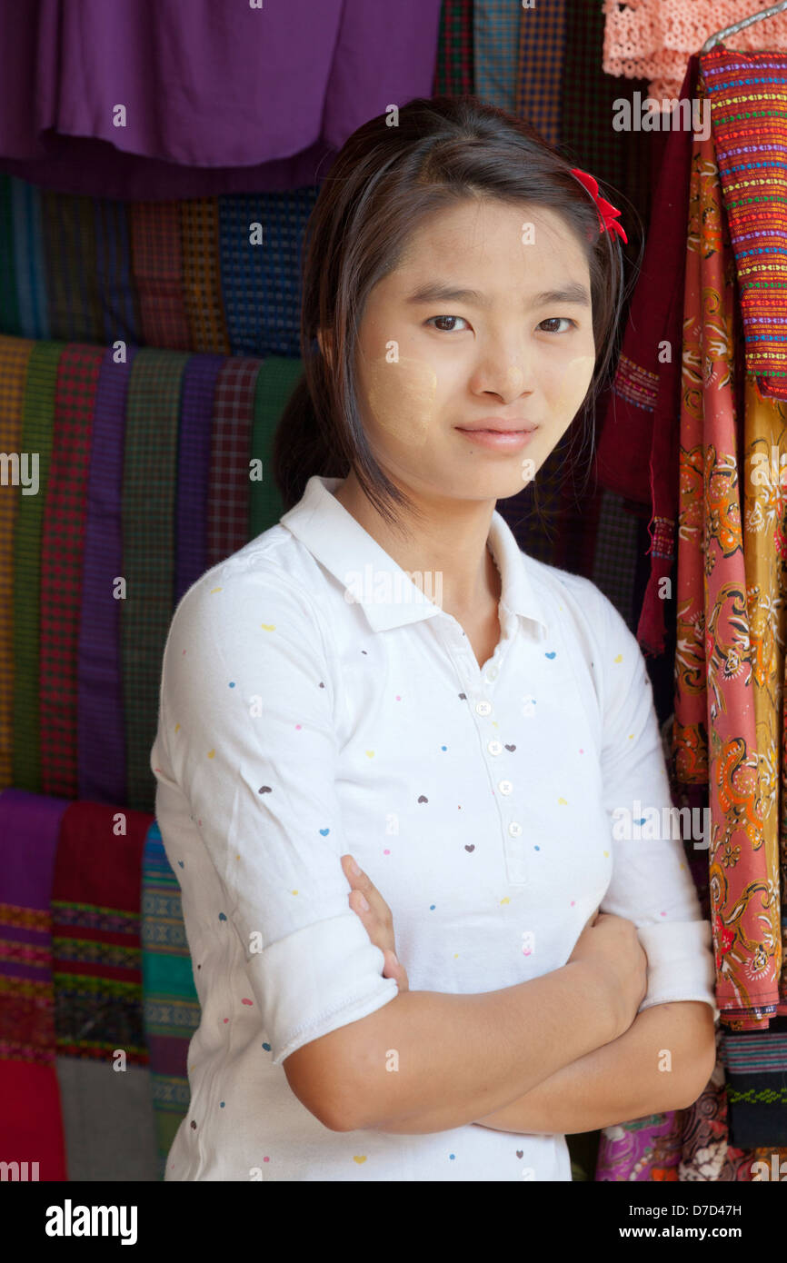 A young Burmese girl selling clothes in Bogyoke (formerly Scott) Market in Yangon, Myanmar Stock Photo