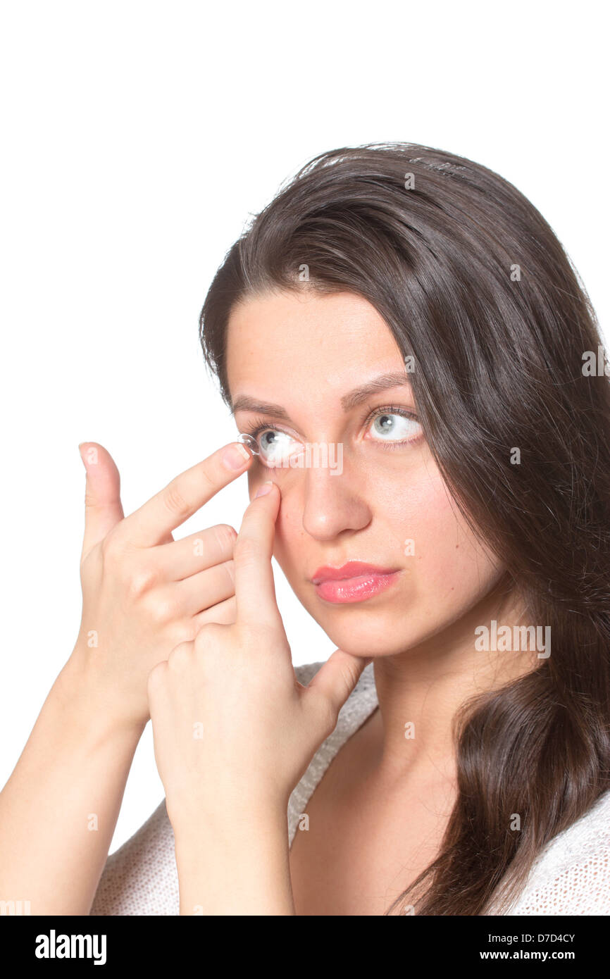 Young woman inserting contact lenses to eye Stock Photo