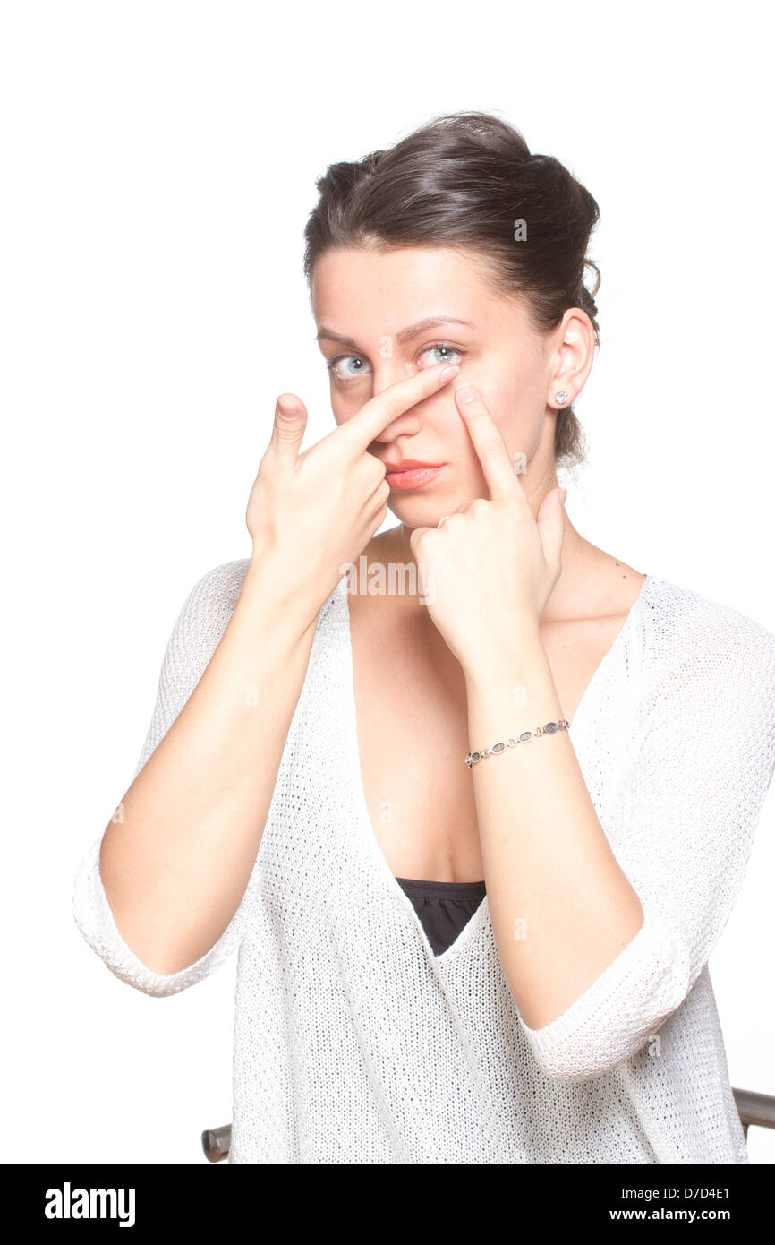 Young woman inserting contact lenses to eye Stock Photo
