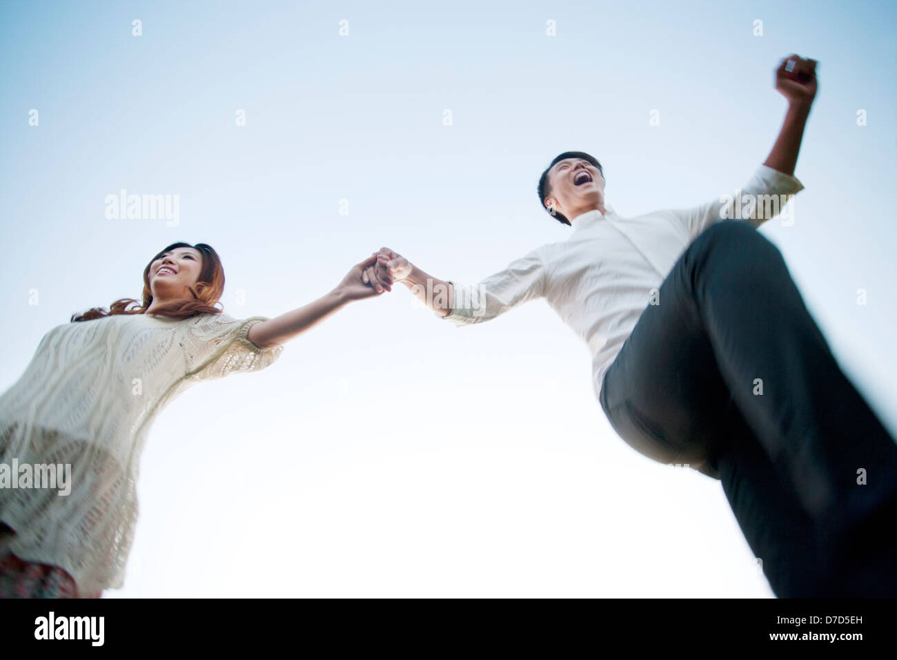 Young couple walking hand in hand Stock Photo - Alamy