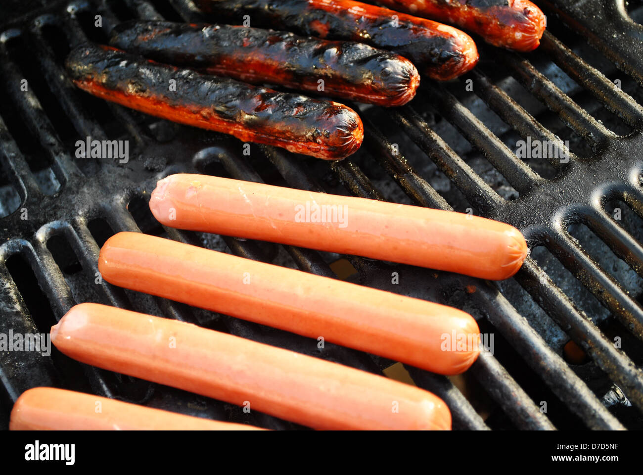 Grilling Hotdogs on a Summer Grill Stock Photo