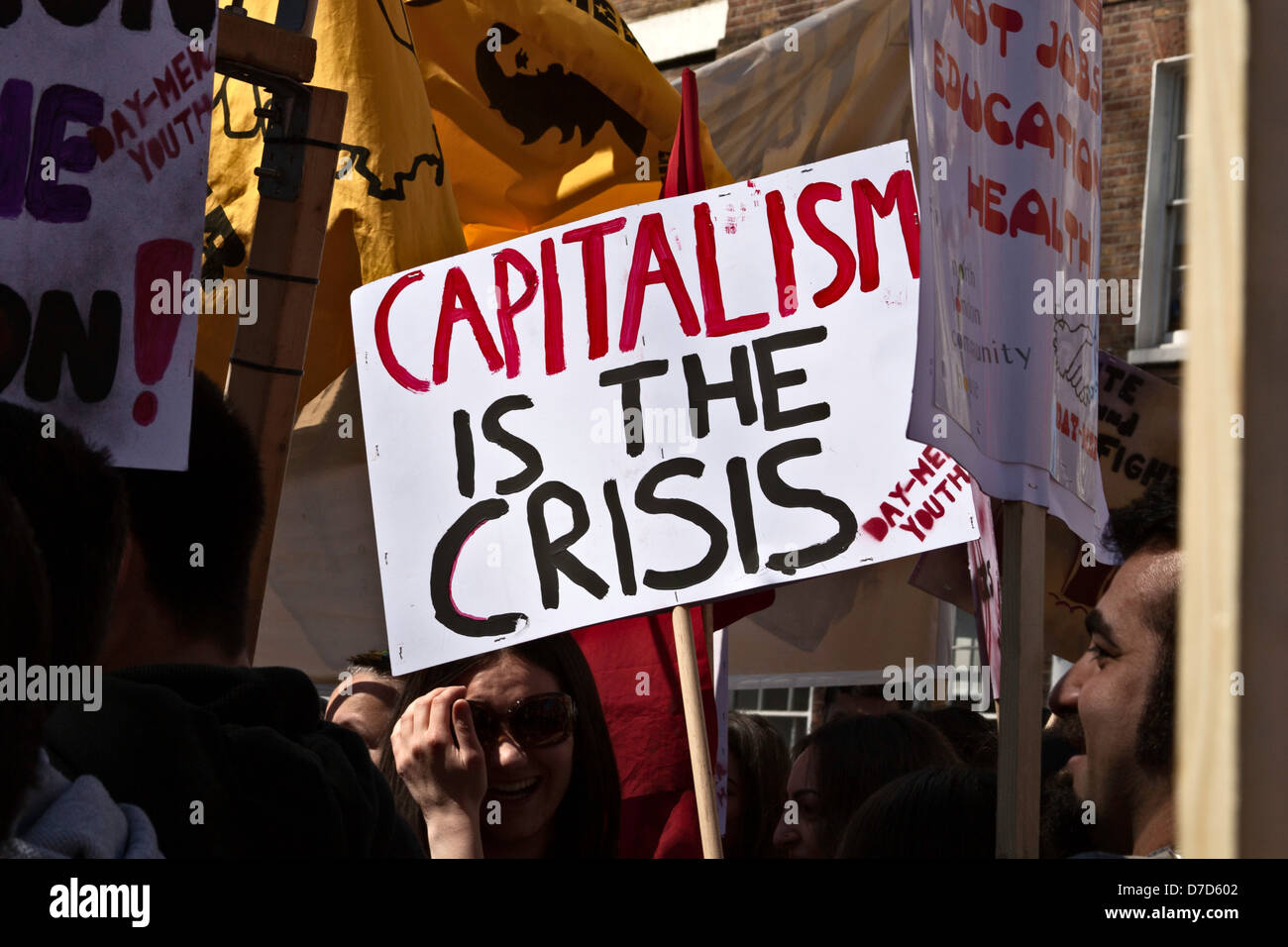 Capitalism is the Crisis - placard at May Day protest rally in London Stock Photo