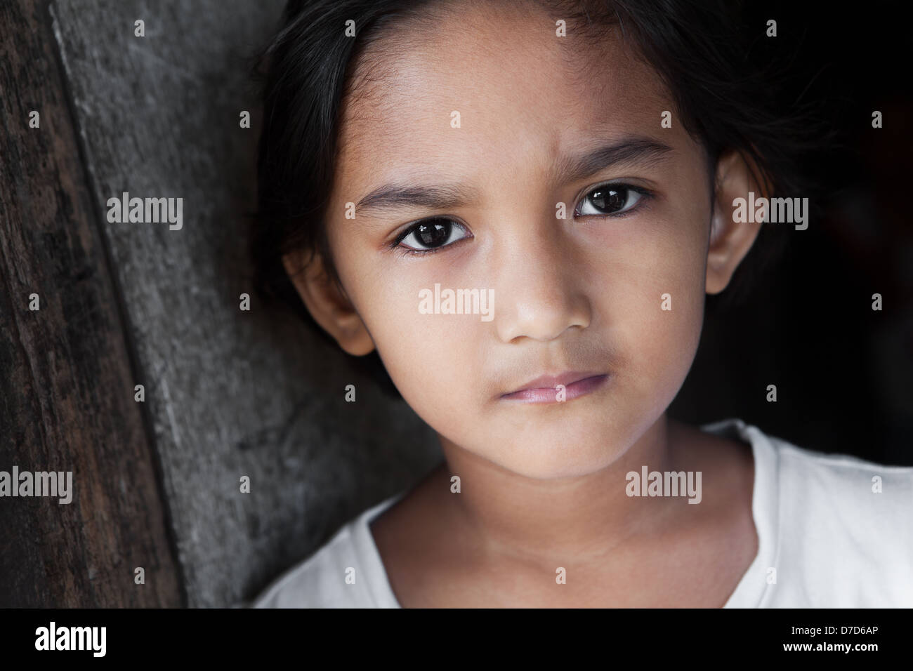 Portrait of a Filipina - young girl from the Philippines against grunge background in natural light Stock Photo