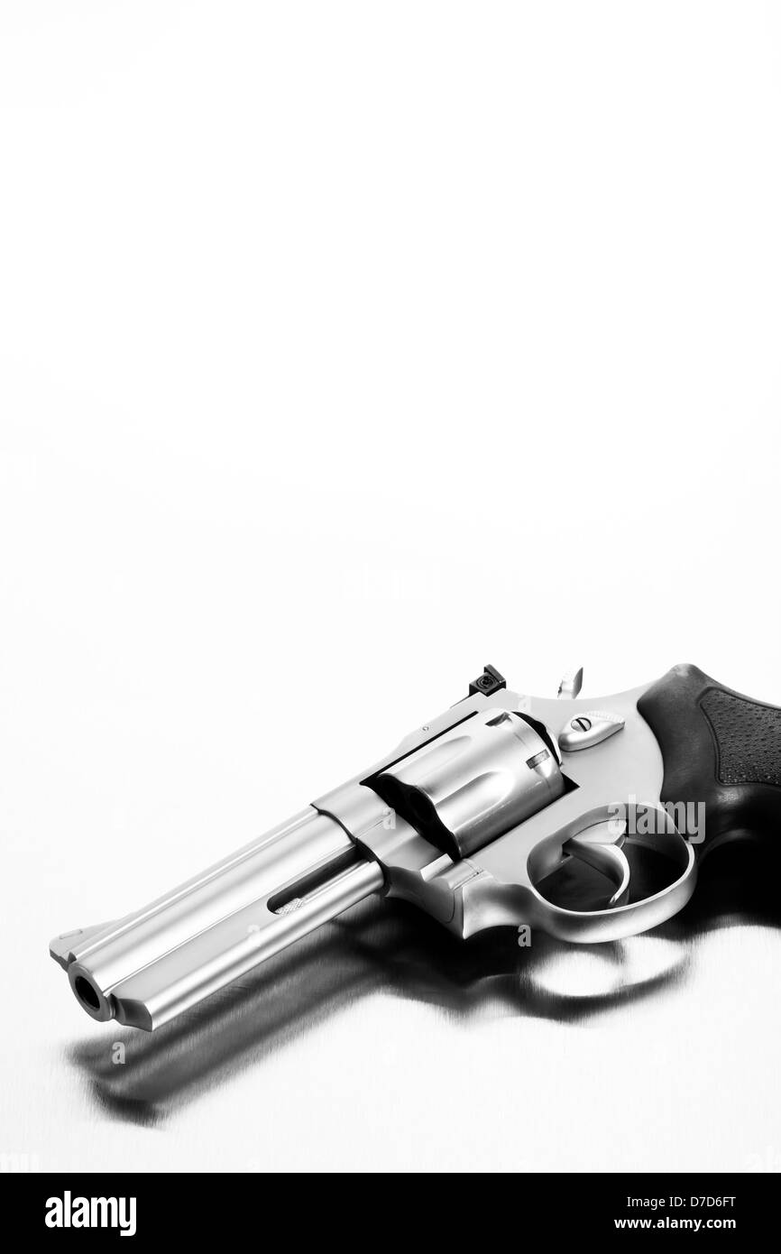 gun on brushed steel surface - modern revolver Stock Photo