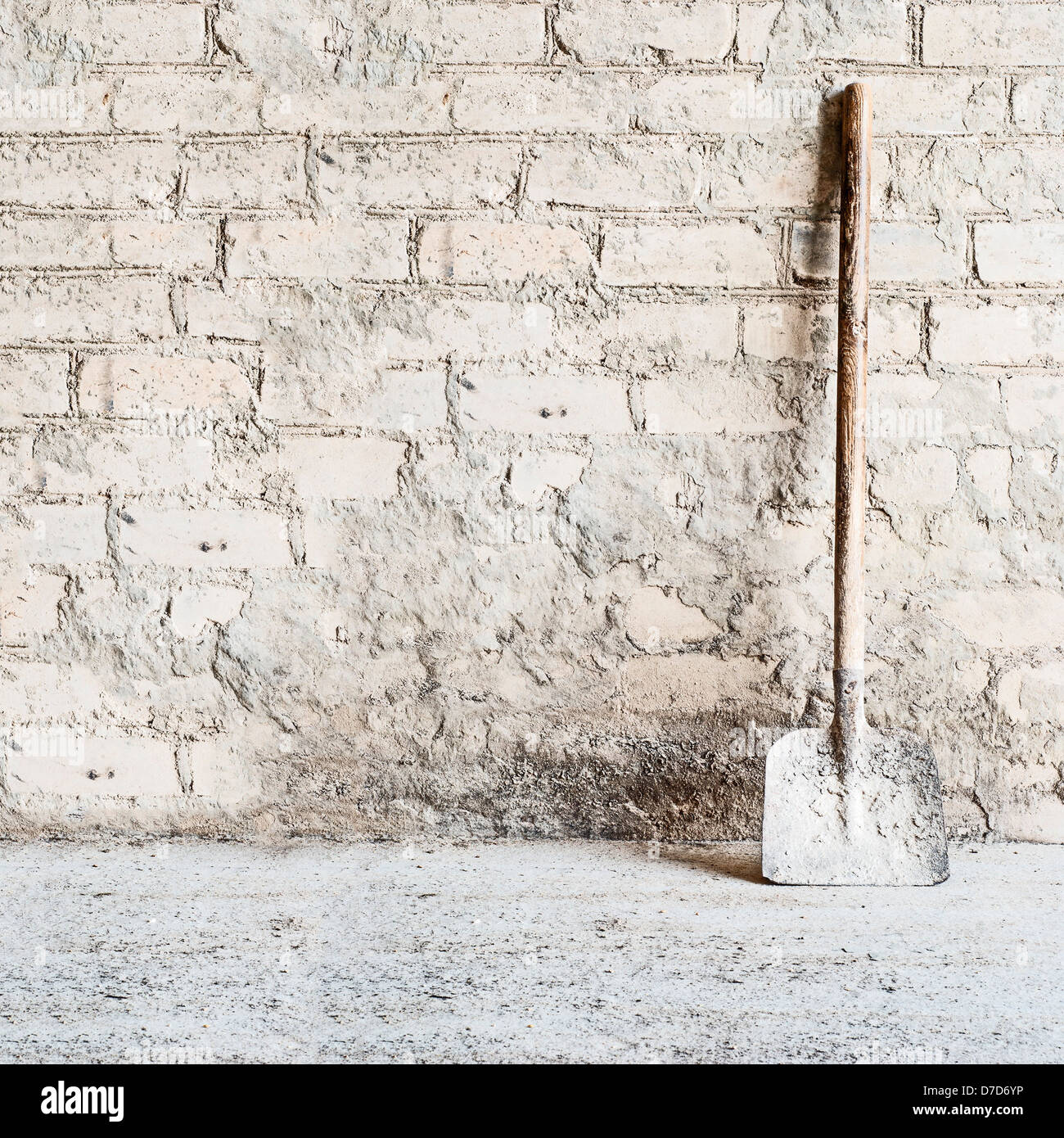 grunge wall background at the mill, shovel near the wall Stock Photo