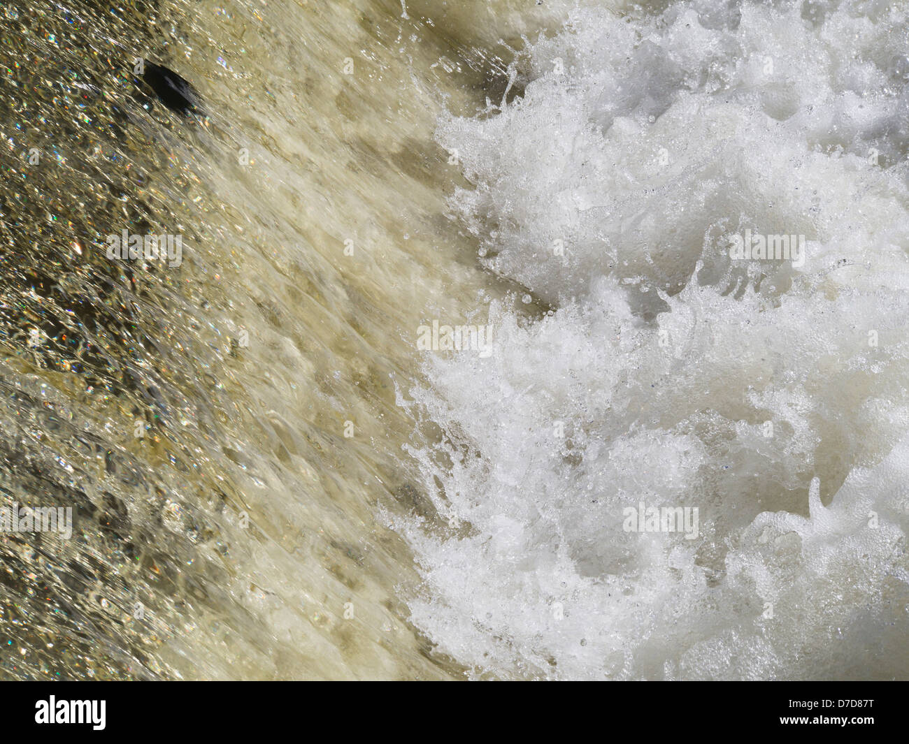 rushing, foaming, bubbling river water in a cascading waterfall Stock Photo