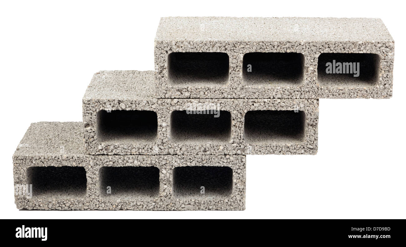 Three gray concrete construction blocks (a.k.a. cinder block breeze block cement block