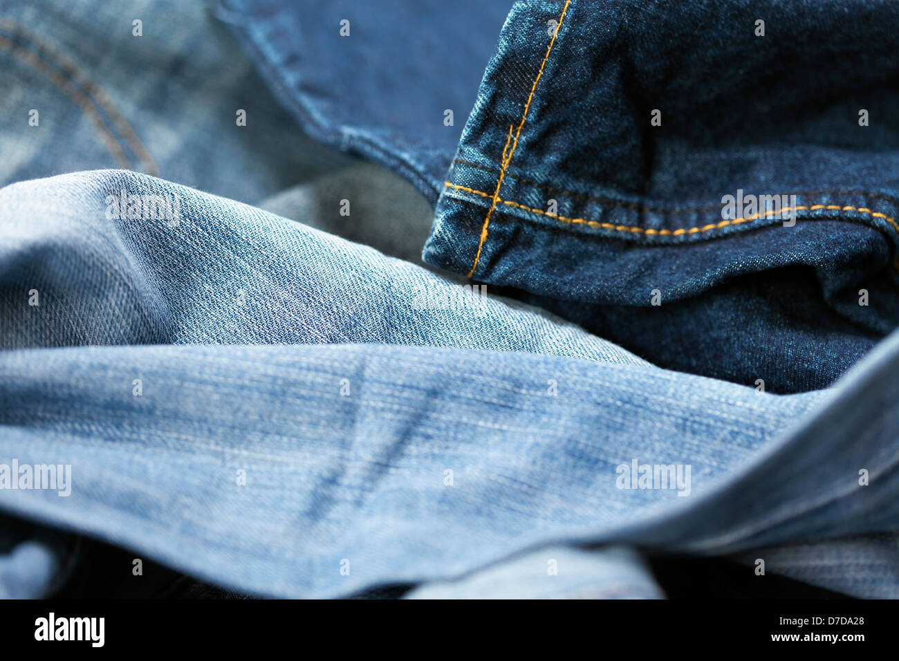 Macro view of a detail from a pair of blue jeans, on the blurry ...