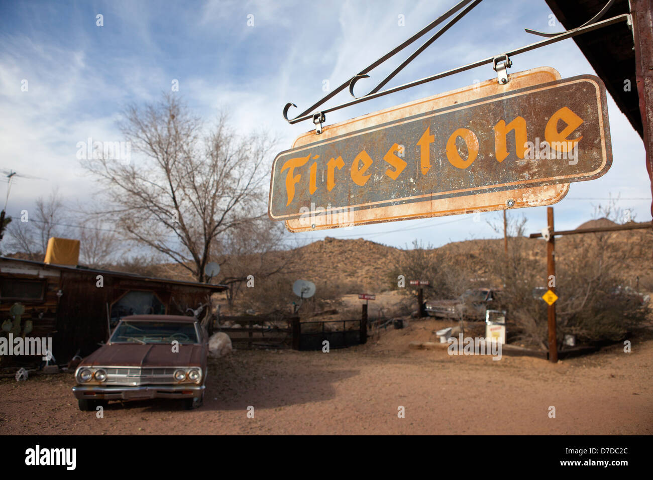 A Firestone sign and an old car at route 66 in Hackberry, Arizona, USA Stock Photo