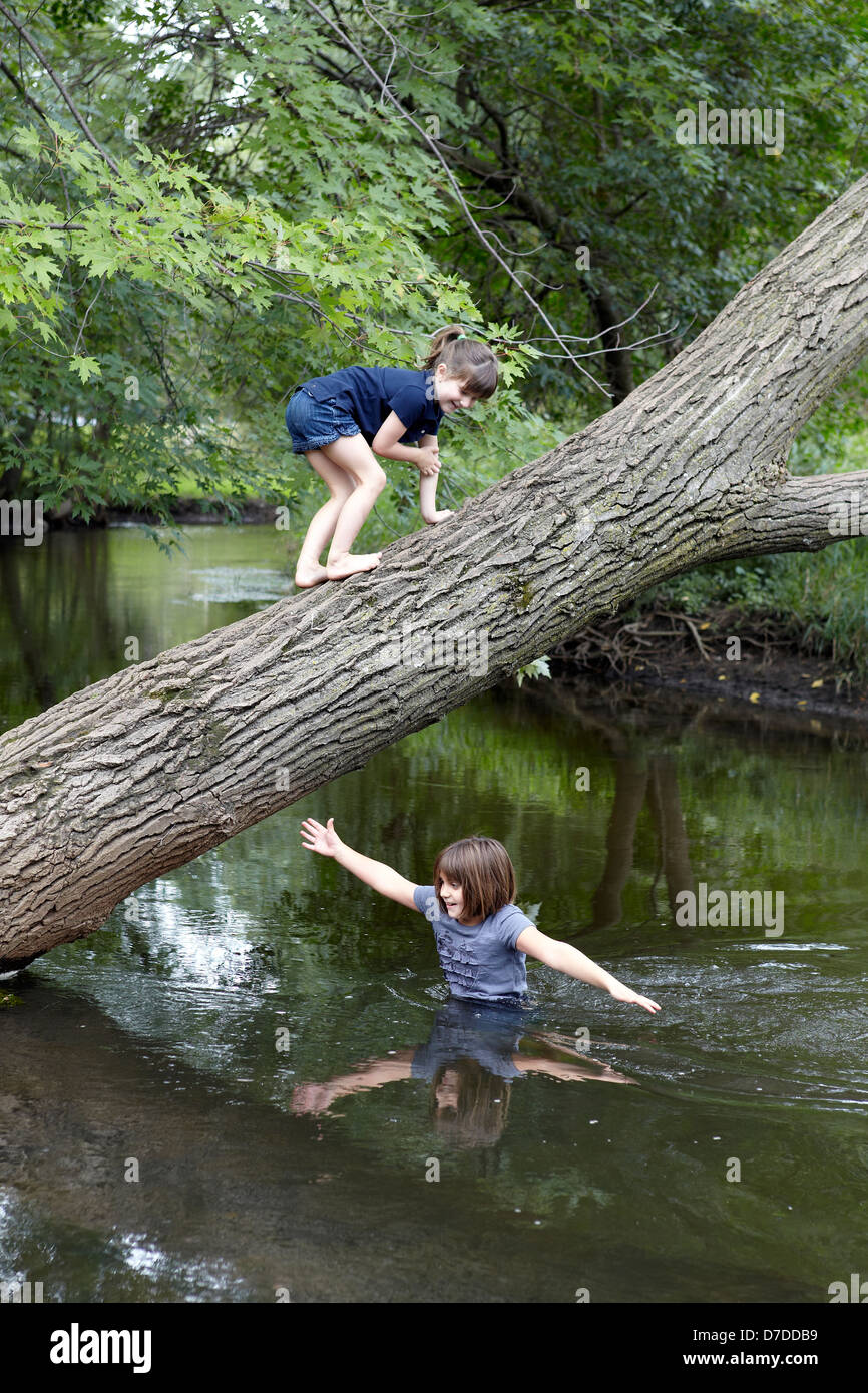 sisters playing and swimming in creek Stock Photo - Alamy