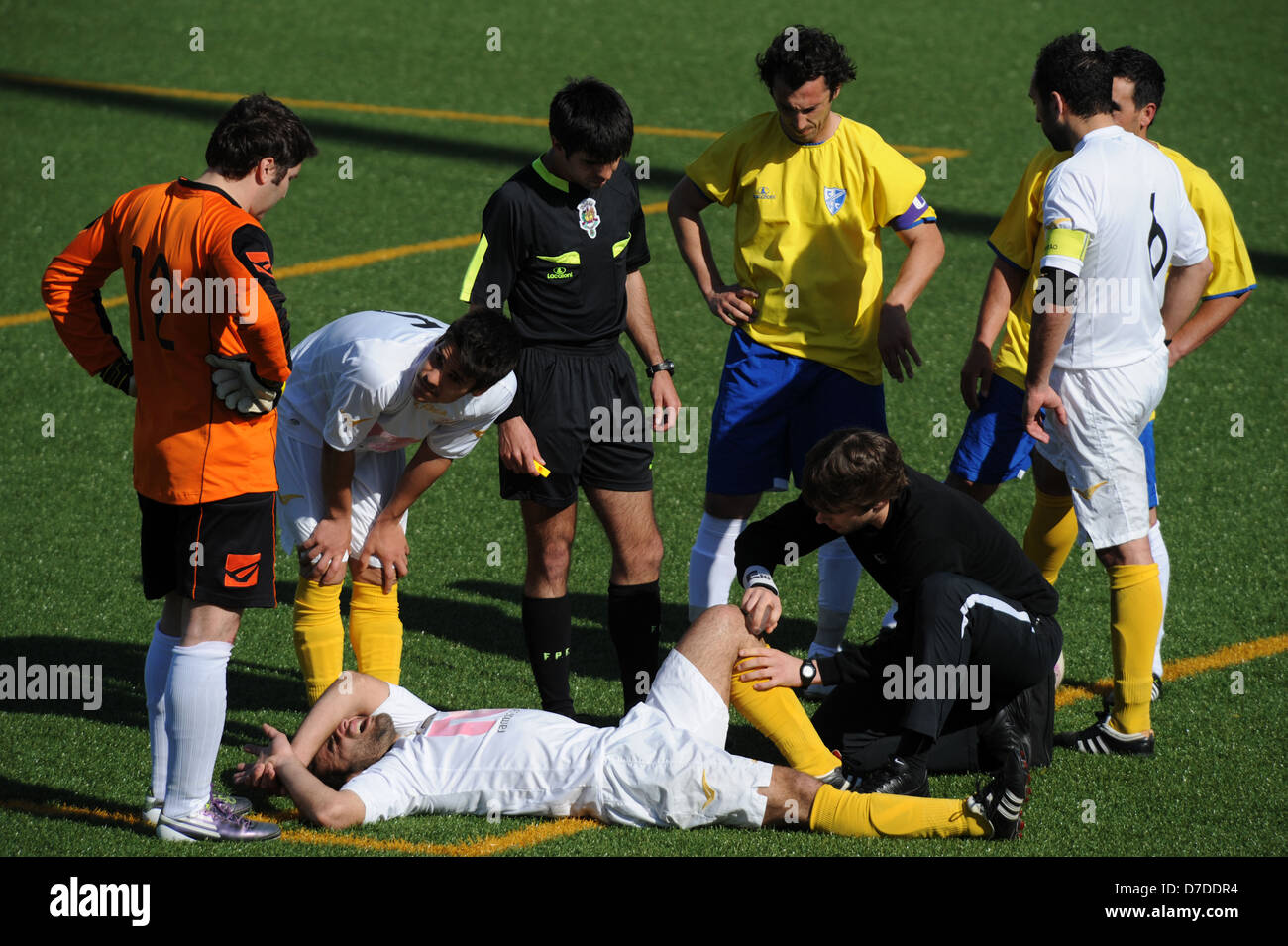 Medic helps injured football player Stock Photo