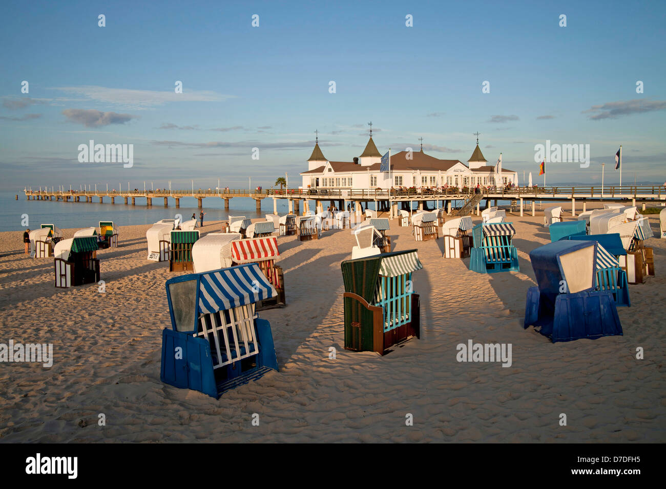 Beach chairs ' Strandkorb ' and the Seebruecke or Pier at the baltic beach of the seaside resort Ahlbeck, Usedom island, Mecklen Stock Photo