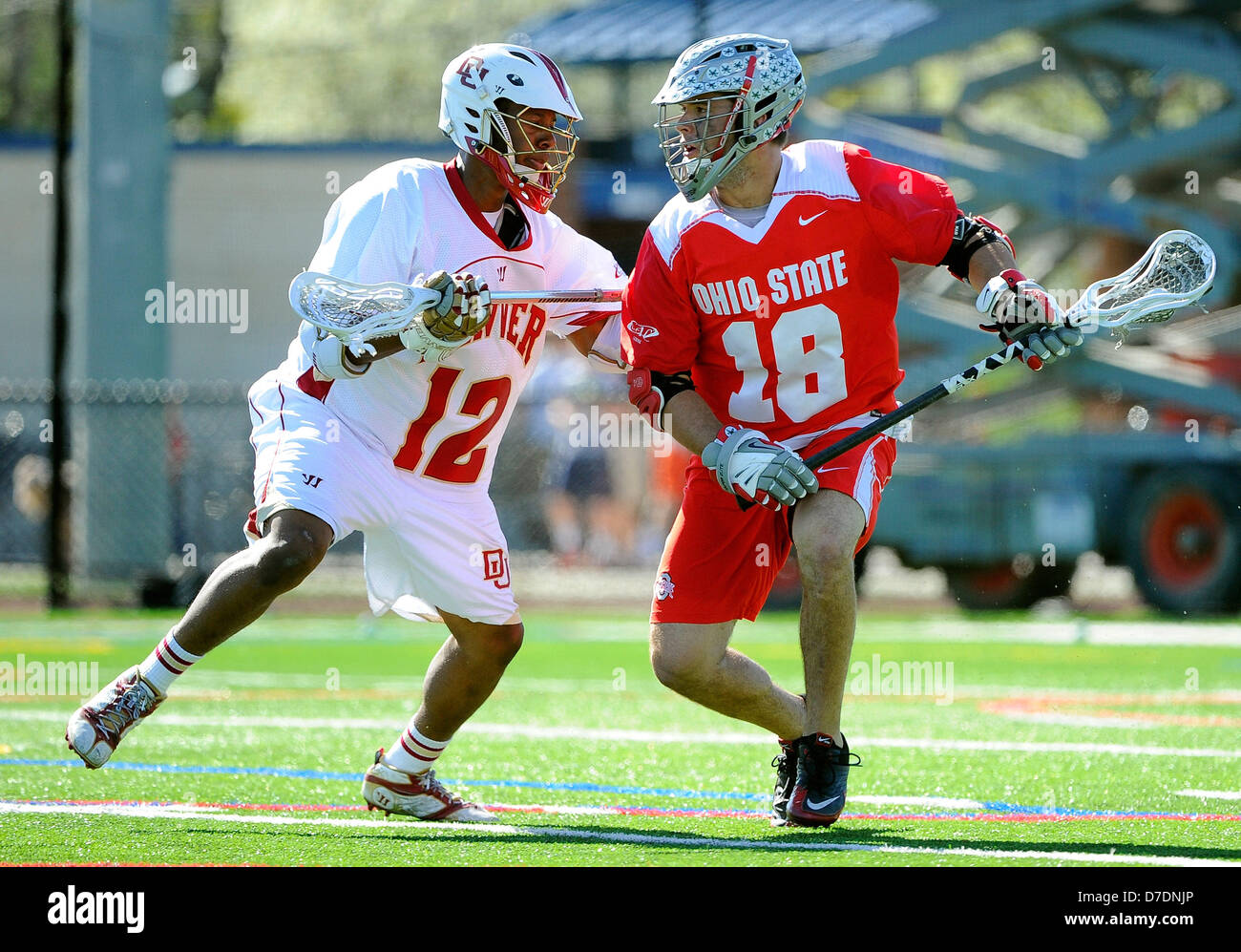 May 4, 2013 - Geneva, New York, USA - May 4, 2013: Ohio State Buckeyes attackman Logan Schuss #18 drives to the goal around Denver Pioneers midfielder Terry Ellis #12 during the second quarter of the 2013 ECAC Men's Lacrosse Tournament Championship game between the Ohio State Buckeyes and the Denver Pioneers at Boswell Field in Geneva, New York. Ohio State won the game 11-10. Stock Photo