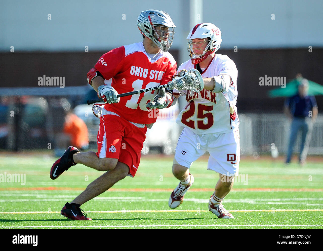 May 4, 2013 - Geneva, New York, USA - May 4, 2013: Ohio State Buckeyes attackman Logan Schuss #18 drives to the goal around Denver Pioneers midfielder Garret Holst #25 during the second quarter of the 2013 ECAC Men's Lacrosse Tournament Championship game between the Ohio State Buckeyes and the Denver Pioneers at Boswell Field in Geneva, New York. Ohio State won the game 11-10. Stock Photo