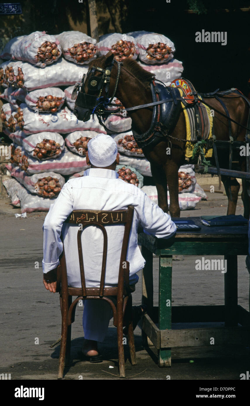 A horse walk past a vendor at the market in Cairo Egypt Stock Photo