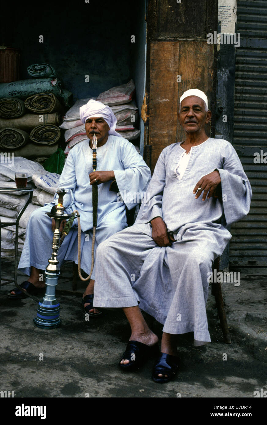 Egyptians wearing traditional Galabyeh garment and smoking Hookah pipe