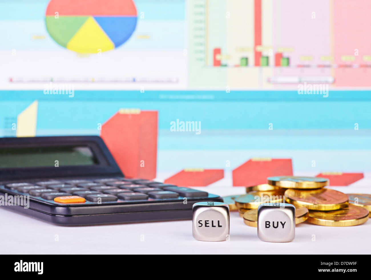 Dices cubes with the words BUY SELL, golden coins, calculator and financial diagrams as background. Selective focus Stock Photo