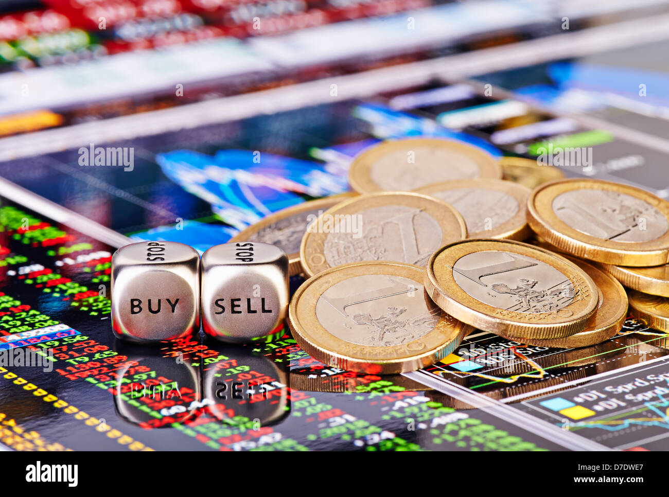 Dices cubes with the words SELL BUY, one-euro coins and a financial chart with columns of figures as the background. Stock Photo