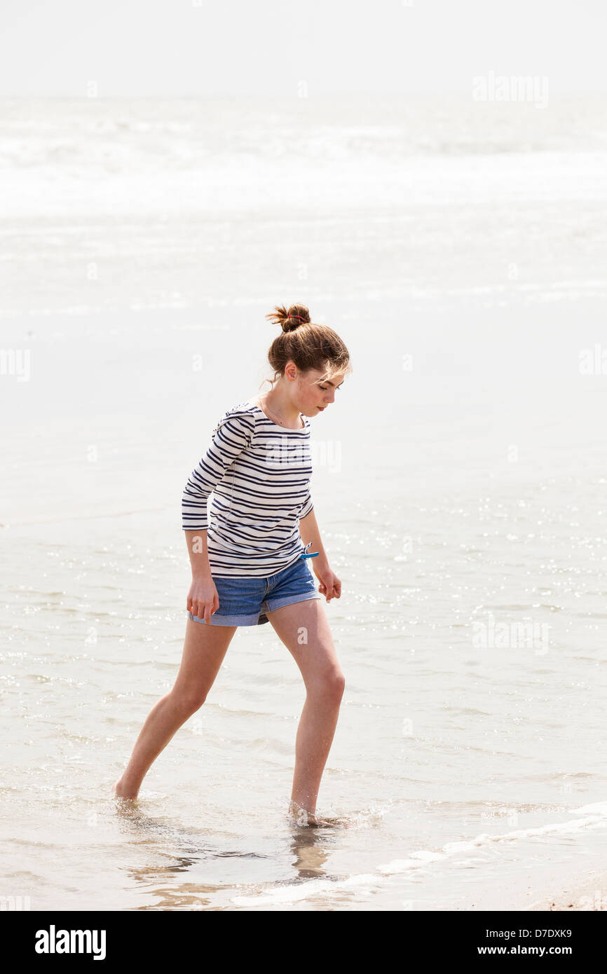 Girl wading in the water at beach Stock Photo