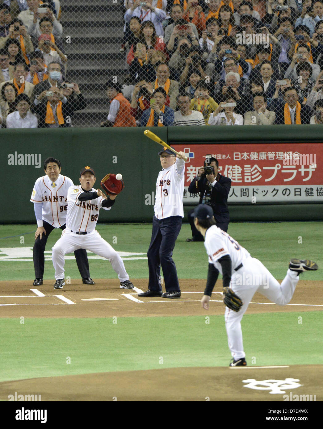 May 5, 2013 - Tokyo, Japan - Former Yomiuri Giants manager Shigeo Nagashima swings a bat as current Giants manager Tatsunori Hara is going to catch the ball thrown as a ceremonial first pitch by former Giants and New York Yankees outfielder Hideki Matsui, right, while Japanese Prime Minister Shinzo Abe, left, plays a role of an umpire prior to the Giants' game against the Hiroshima Carp at Tokyo Dome in Tokyo Sunday, April 5, 2013. Matsui and Nagashima received the People's Honor Award from Abe at an elaborate ceremony before the game. (Credit Image Â©Yoshikazu Okunishi,, Pool)/Jana Press/ZUMA Stock Photo